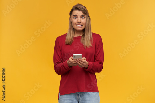 Картината върху платно Blonde young woman looks insecure as if she's in trouble or an awkward situation