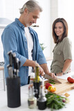 Couple cooking together in their kitchen at home.