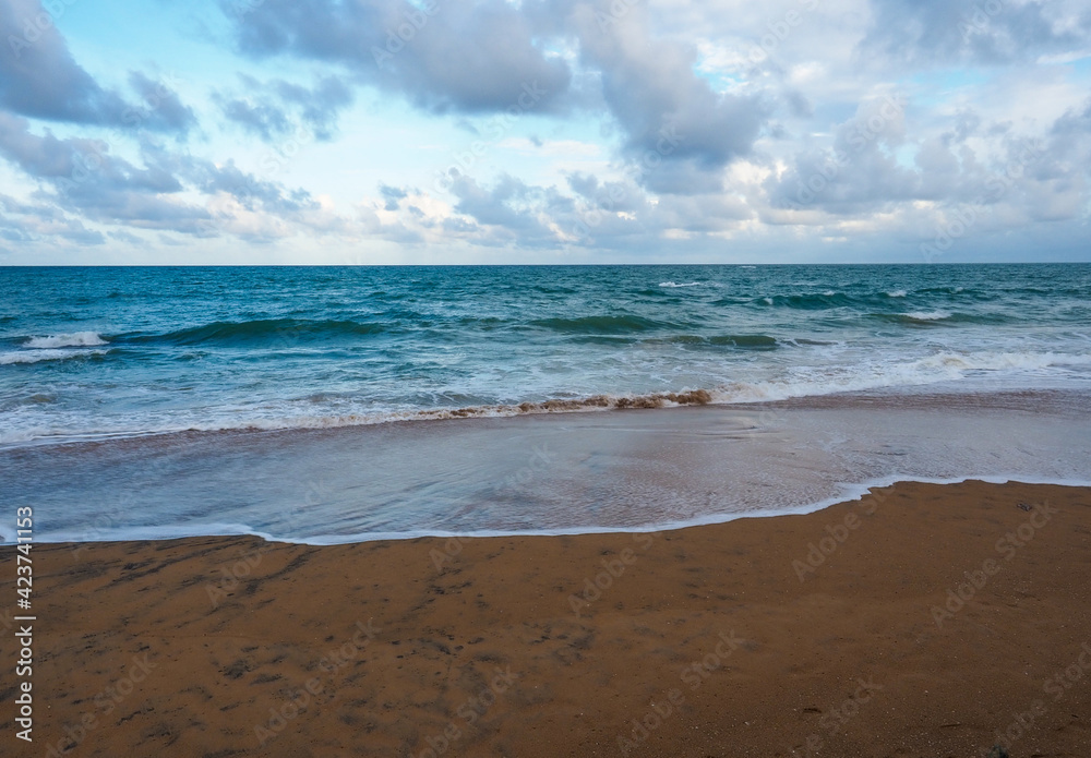 the beach in the morning with soft blue wave and sugar sand, cloudy sky