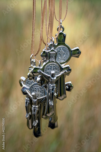 Metal pilgrimage crosses hanging on thongs photo