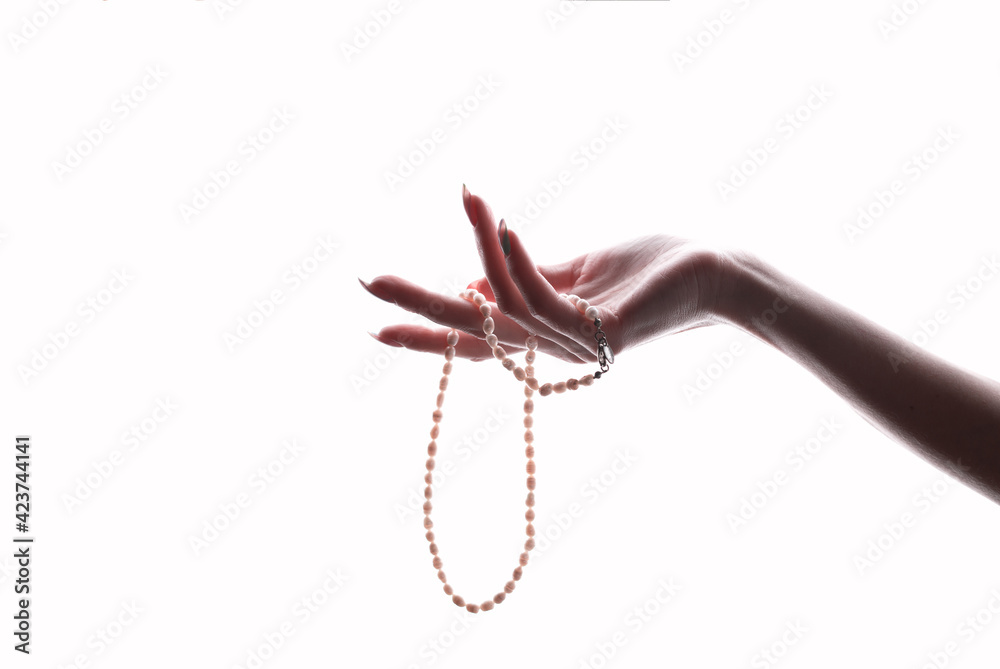 Fototapeta premium female graceful hand holding pearls