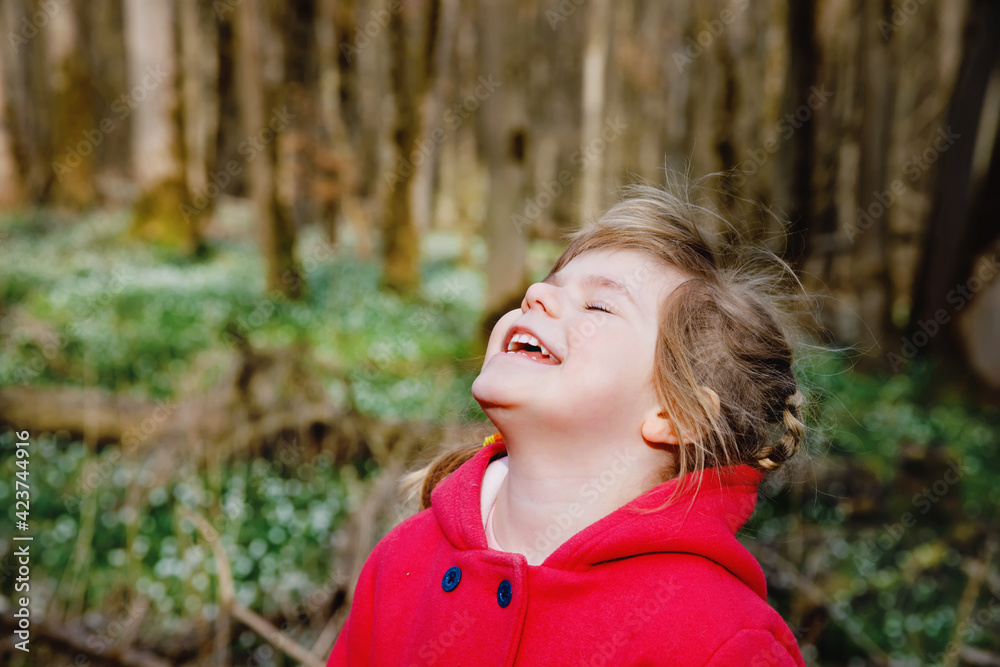 Portrait of cute little toddler preschool girl. Happy smiling child looking at the camera. Girl in spring forest, making family outdoor adventure walk with family. Portrait of cute little toddler preschool girl. Happy smiling child looking at the camera. Girl in spring forest, making family outdoor adventure walk with family.