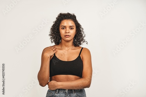 Photo of attractive black woman, wears black top. Isolated over white background. Natural beauty and health