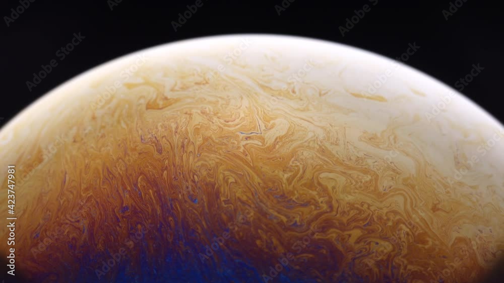 Close up of hidden beautiful and abstract colourful of half soap bubble isolate with black background.
