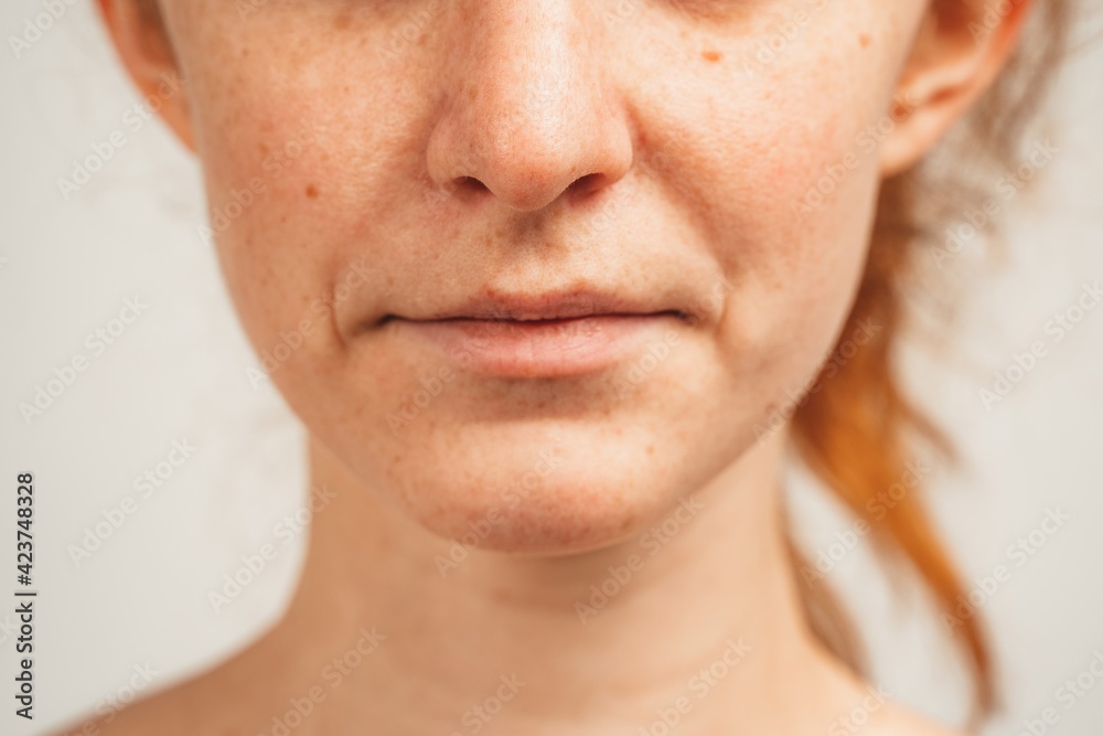 Close up photo of lower face of redhead young woman. Isolated over white background. Natural beauty and health