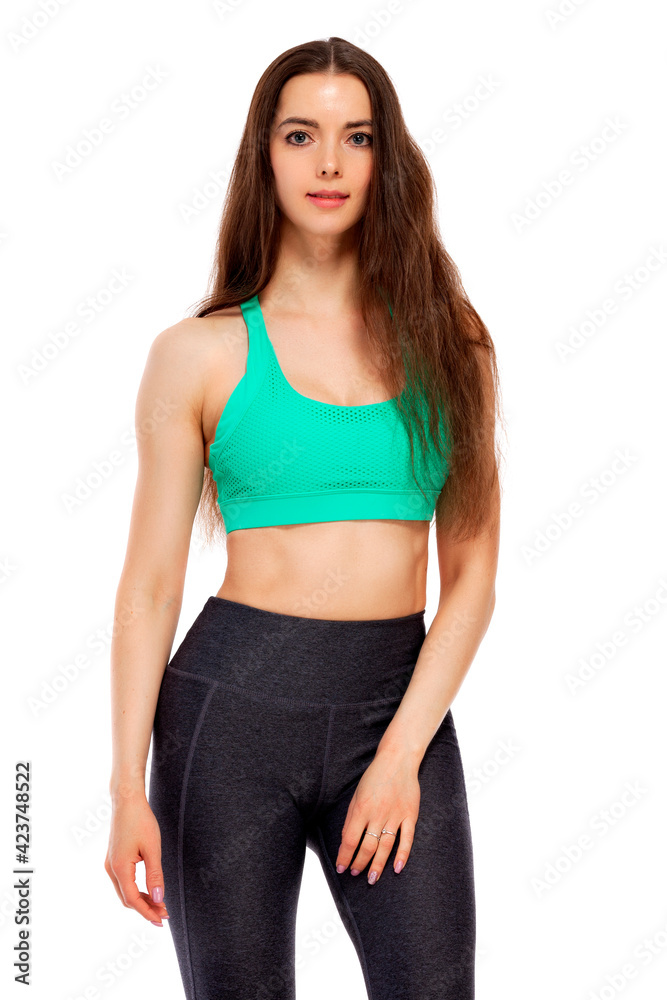 Young woman wearing sports outfit. Isolated on white background Young woman wearing sports outfit. Isolated on white background