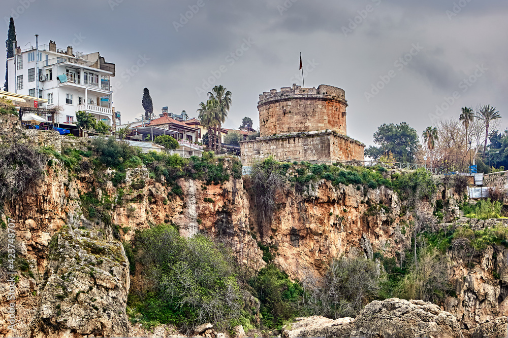View of cliff with fortress in old town of Antalya from side of Mediterranean Sea.