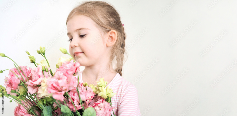 Adorable little girl holding bouquet of flowers. Cute happy child with flower bouquet. Happy Easter. Hello spring banner Adorable little girl holding bouquet of flowers. Cute happy child with flower bouquet. Happy Easter. Hello spring banner