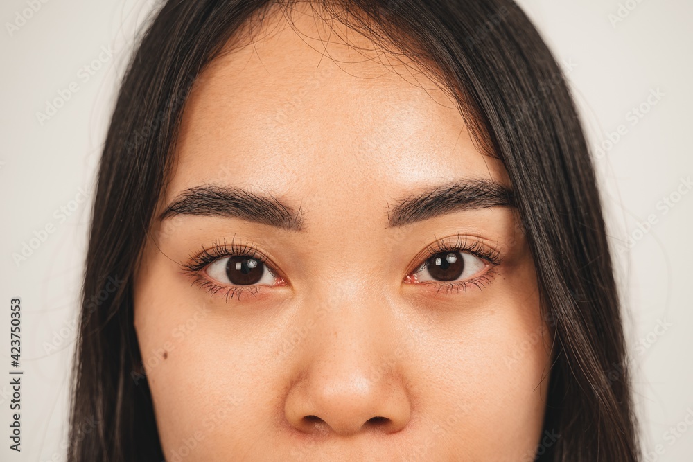 Close up photo of natural woman face. Isolated over white background. Natural beauty and health Close up photo of natural woman face. Isolated over white background. Natural beauty and health