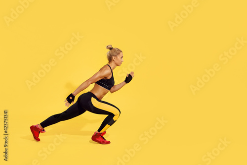 beautiful athletic woman in black sportswear running