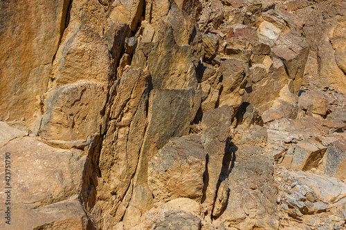 Textured surface of a rock with cracks.