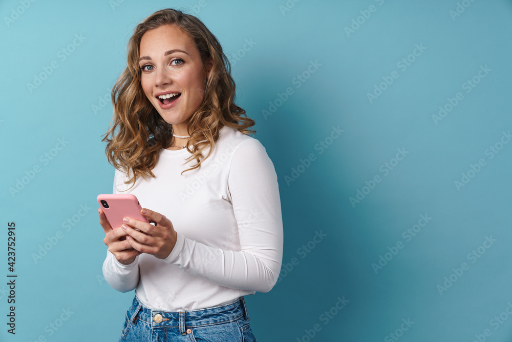 Blonde happy woman using mobile phone and smiling Blonde happy woman using mobile phone and smiling