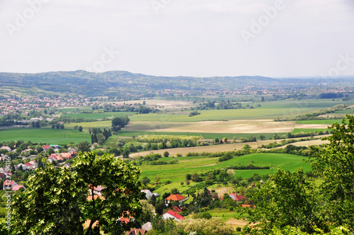 Valley view with fields, villages and mountains in the background.