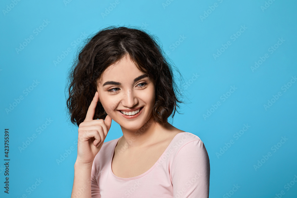 Fototapeta premium cute curly brunette woman thinking about something