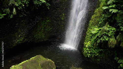 A tropical waterfall seen from the bottom and moving to the top of the waterfall found in a tropical forest in Ecuador, South America