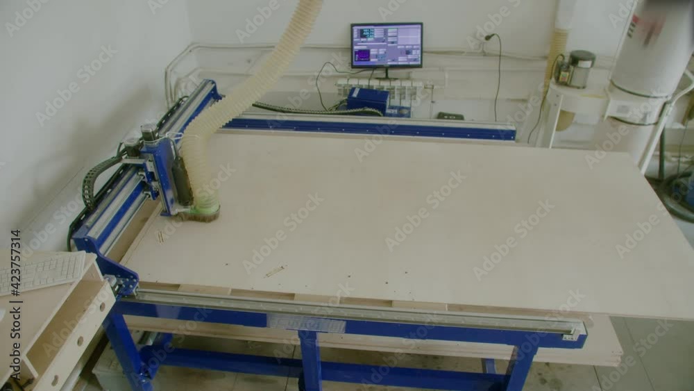 Milling machine cut letters out of plywood. Flying flakes shavings