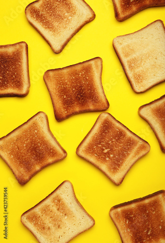 Toast bread on a bright yellow background. Top view, flat lay