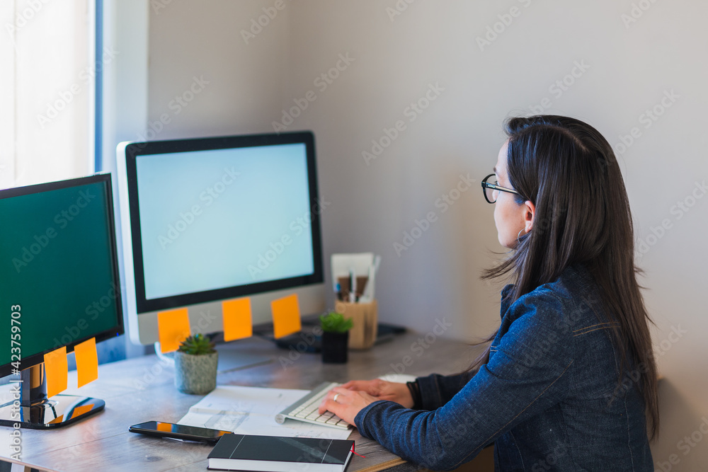 young woman architect working on her computer from home young woman architect working on her computer from home