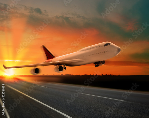 Modern white airplane landing on runway