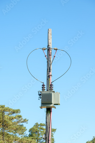 Electric mast under sunny sky photo