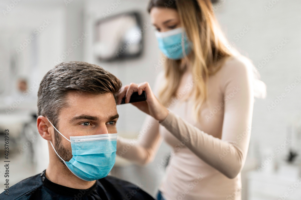 People wearing masks in hair salon to stop virus infection
