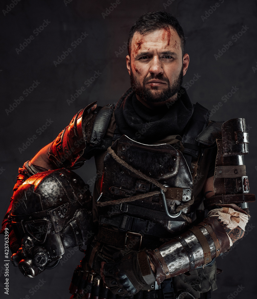 Bearded apocalyptic survivor with helmet in dark background