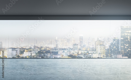Empty apartment with a panoramic window, concrete floor, city view, real estate, advertising concept