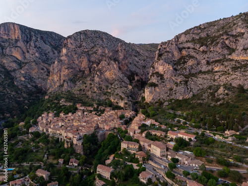 an aerial view of a small town in France. Moustiers Sainte Marie in France is also called the Monk Town. 