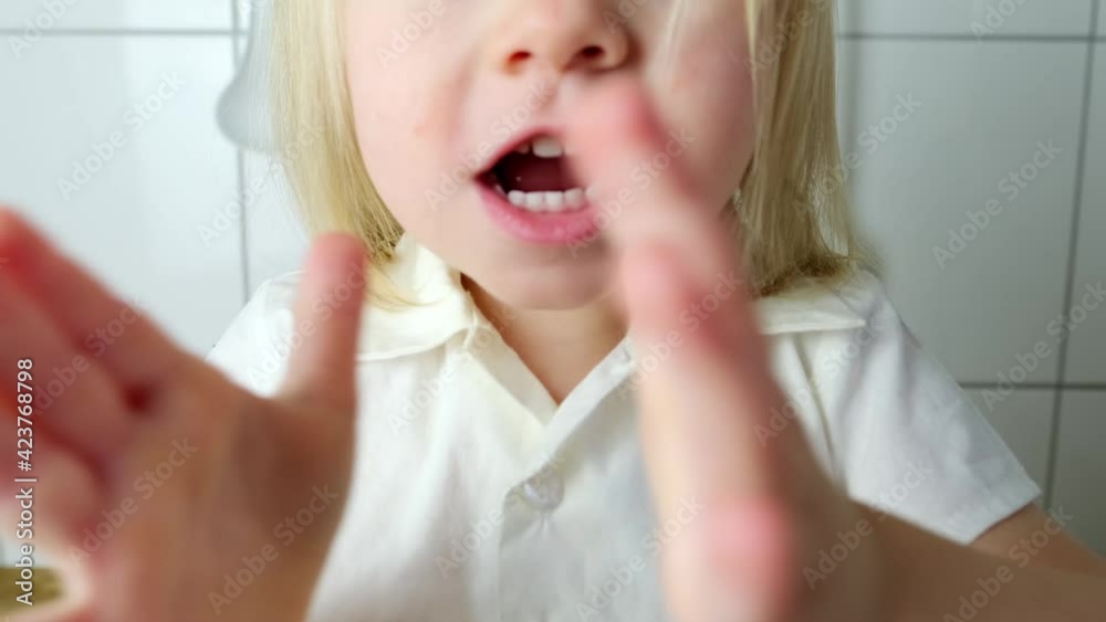 little child, baby, blonde girl smiling, clapping her hands, part of the head close-up, happy childhood concept, baby jokes little child, baby, blonde girl smiling, clapping her hands, part of the head close-up, happy childhood concept, baby jokes
