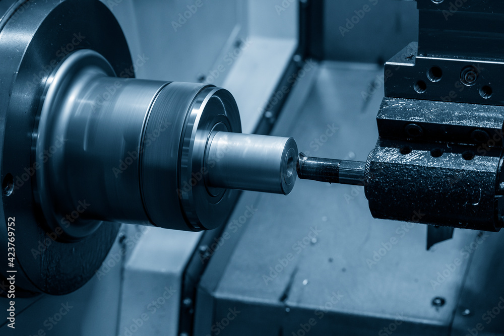 The CNC lathe machine bore cutting the metal shaft parts. The hi-technology metal working processing by CNC turning machine . The CNC lathe machine bore cutting the metal shaft parts. The hi-technology metal working processing by CNC turning machine .