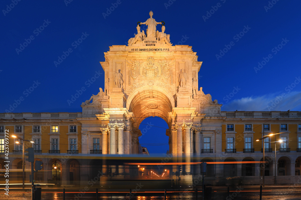 VIiew of Triumphal Arch with light tails on Commerce Square in Lisbon, Portugal. Famous city center tourist travel attraction