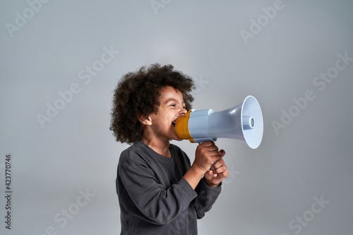 Leinwand Poster Little african american kid talking into megaphone