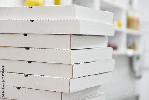 stack of white cardboard pizza boxes