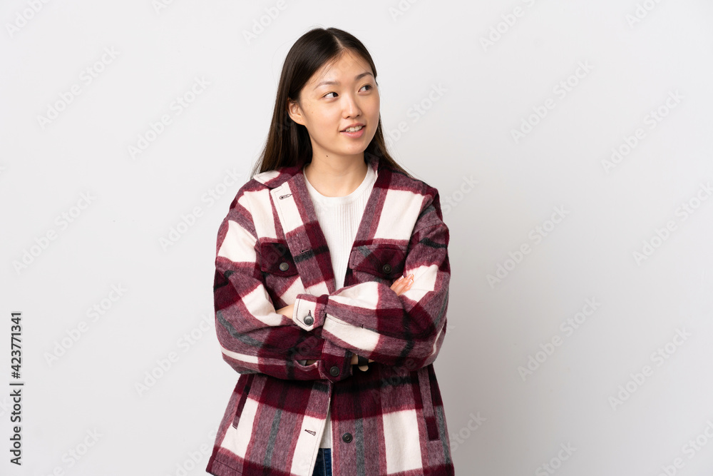 Young Chinese girl over isolated white background looking to the side Young Chinese girl over isolated white background looking to the side
