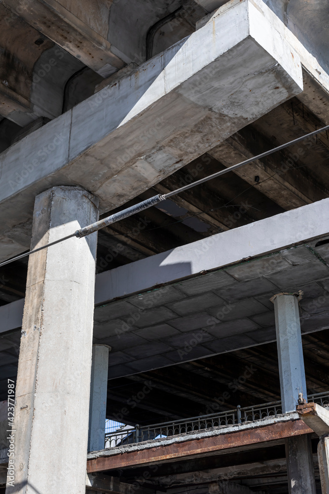 Reinforced Concrete Structure of Highway Overpass. Cracking of concrete beams under the bridge. View From Bottom Down. Reinforced Concrete Structure of Highway Overpass. Cracking of concrete beams under the bridge. View From Bottom Down.