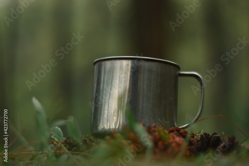 practical aluminum mug brought when camping in the pine forest