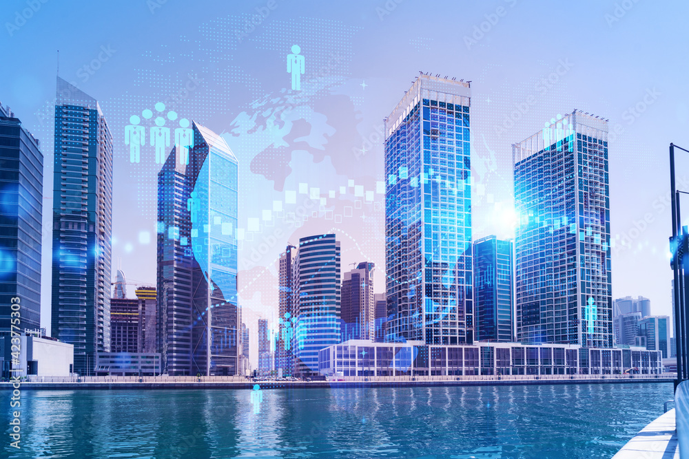 Fototapeta premium Skyscrapers of Dubai business downtown. International hub of trading and financial services. Social network icons hologram, concept of people connection. Double exposure. Dubai Canal waterfront.