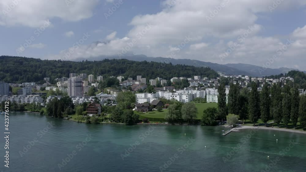 Aerial flying above Lake Luzern in Switzerland towards little village ungraded Aerial flying above Lake Luzern in Switzerland towards little village ungraded