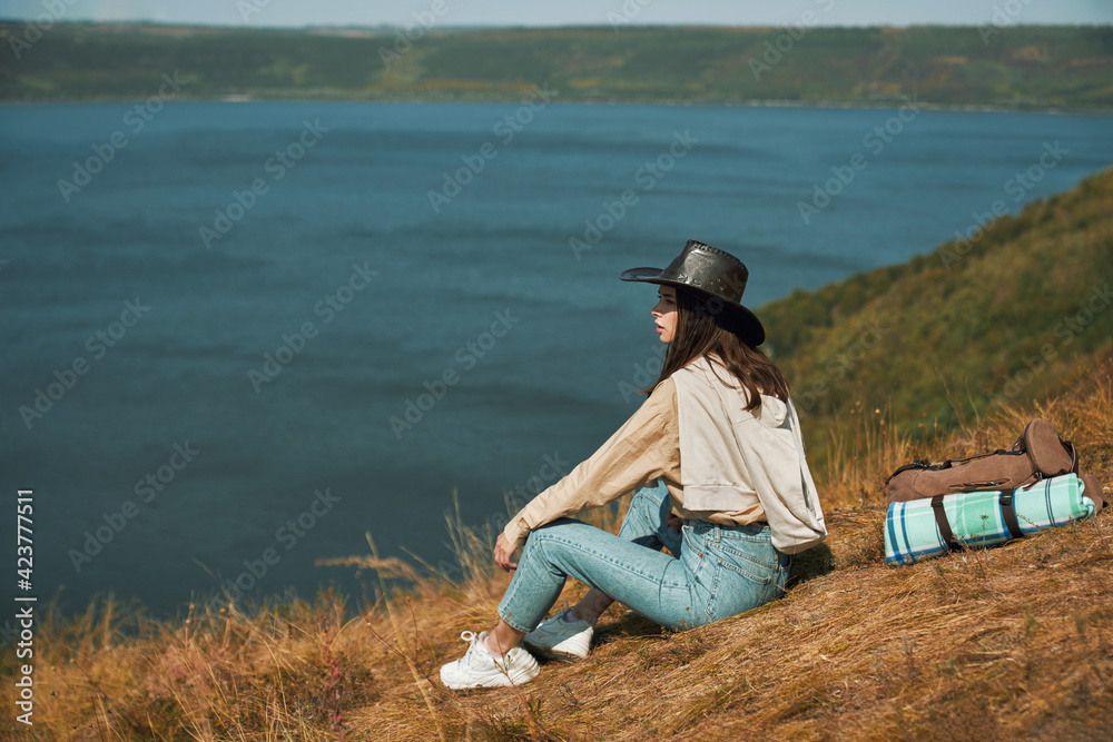 Positive woman looking at Dniester river from high hill