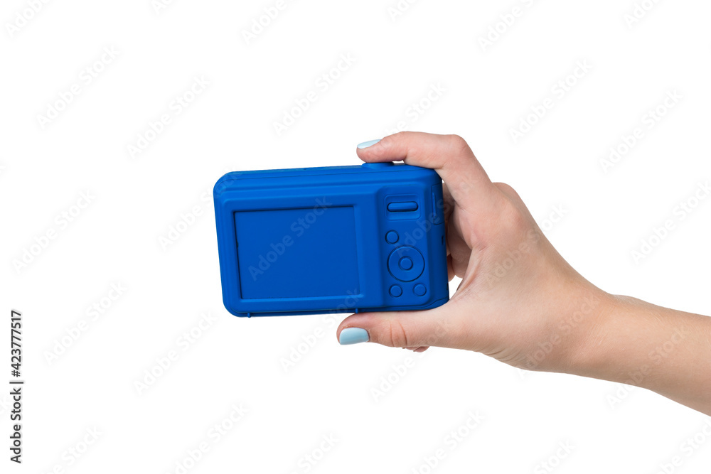 A woman's hand with a blue camera isolated on a white background. A woman's hand with a blue camera isolated on a white background.