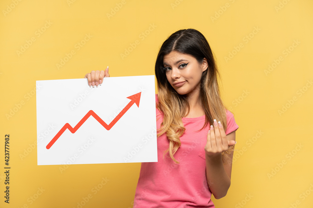 Young Russian girl isolated on yellow background holding a sign with a growing statistics arrow symbol and doing coming gesture Young Russian girl isolated on yellow background holding a sign with a growing statistics arrow symbol and doing coming gesture