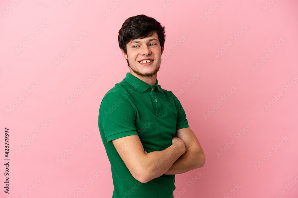 Young Russian man isolated on pink background with arms crossed and happy Young Russian man isolated on pink background with arms crossed and happy