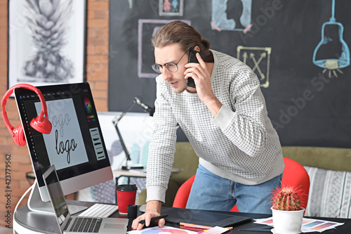 Young male designer working...