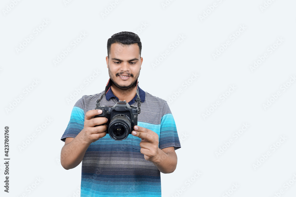 man with a professional DSLR camera, showing thumbs up, checking photos, showing the camera, operating the camera, with a blank white plate man with a professional DSLR camera, showing thumbs up, checking photos, showing the camera, operating the camera, with a blank white plate
