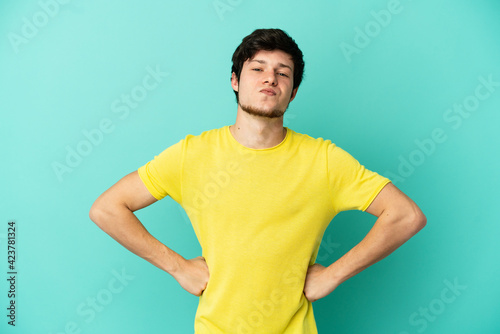 Young Russian man isolated on blue background angry