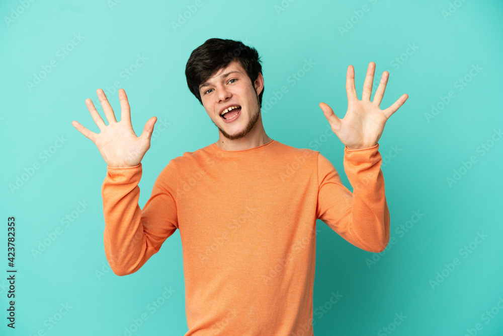 Young Russian man isolated on blue background counting ten with fingers Young Russian man isolated on blue background counting ten with fingers
