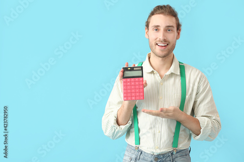 Young man with calculator o...