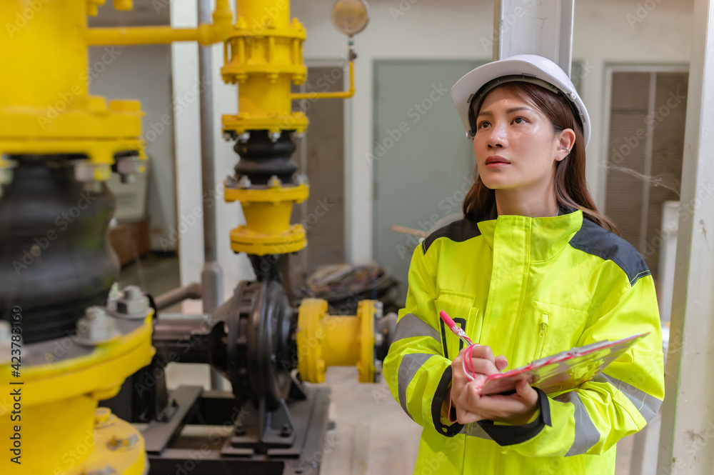 custom made wallpaper toronto digitalAsian engineer wearing glasses working in the boiler room,maintenance checking technical data of heating system equipment,Thailand people