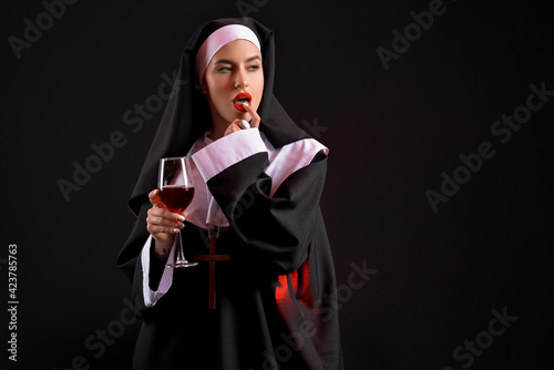 Sexy nun with glass of wine...