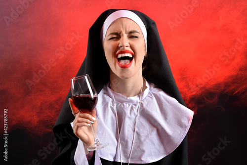 Naughty nun with glass of w...